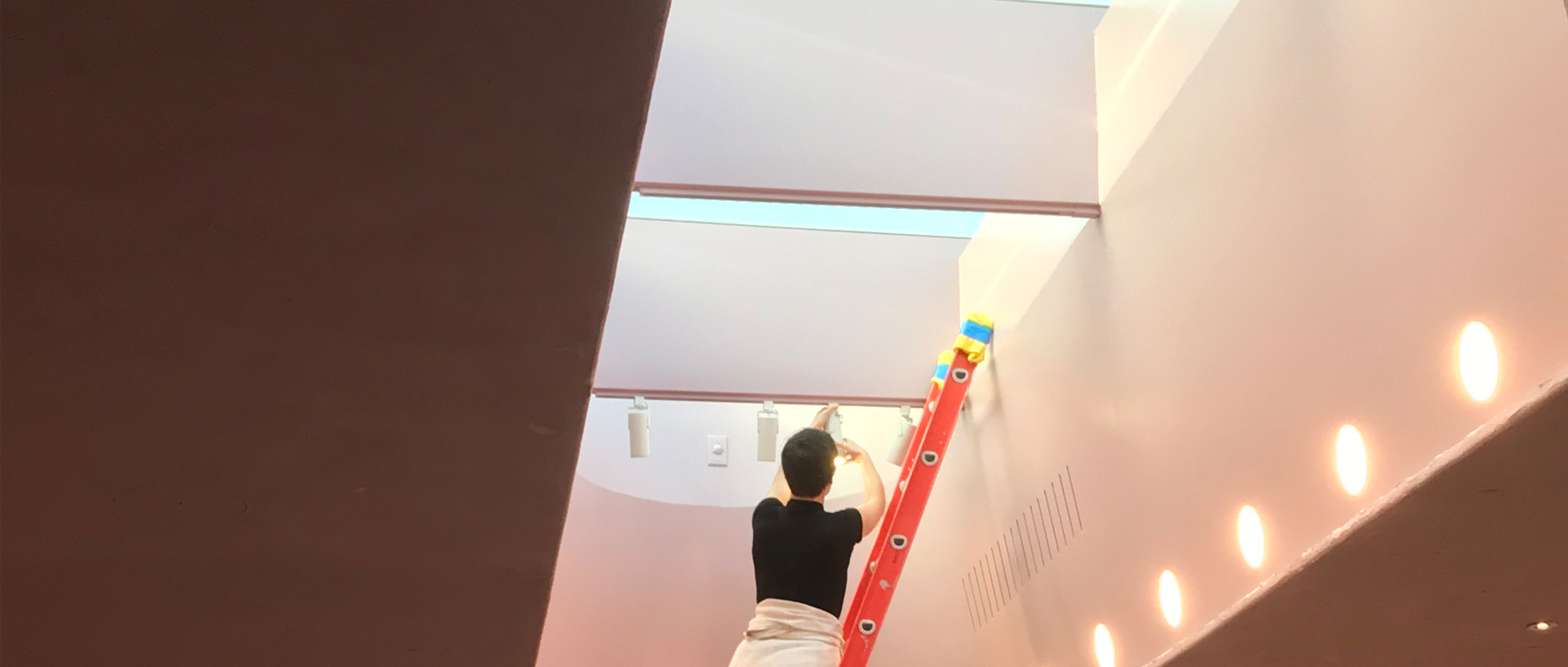 Sara McElroy installing light fixtures 