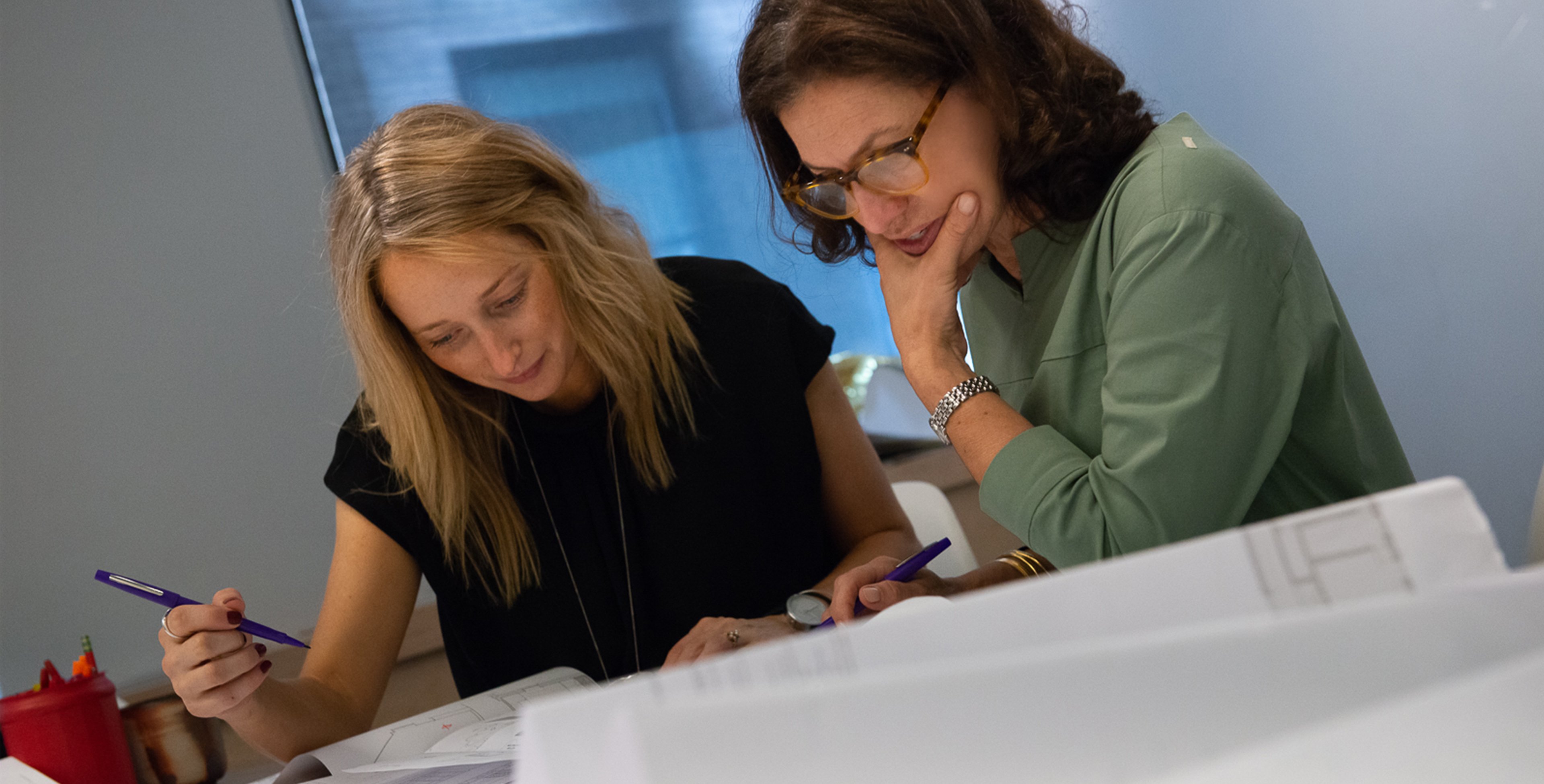Suzan and Erin working on a project together for Tillotson Design Associates